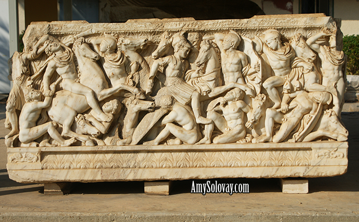Roman Sarcophagus Dating Back to the Third Century AD. The marble sculptures on three sides of this piece depict a battle between the Romans and the Barbarians. On the fourth side, lions are pictured attacking bulls. This artifact is on display at the antiquities courtyard museum in Ashkelon, Israel.