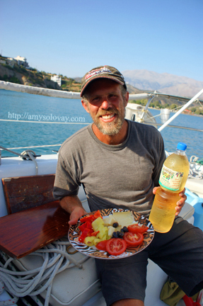 Mike with a plate of Greek olives, cheese and veggies, aboard our sailboat in Agia Galini, Crete, Greece. Mike with a plate of Greek olives, cheese and veggies, aboard our sailboat in Agia Galini, Crete, Greece.